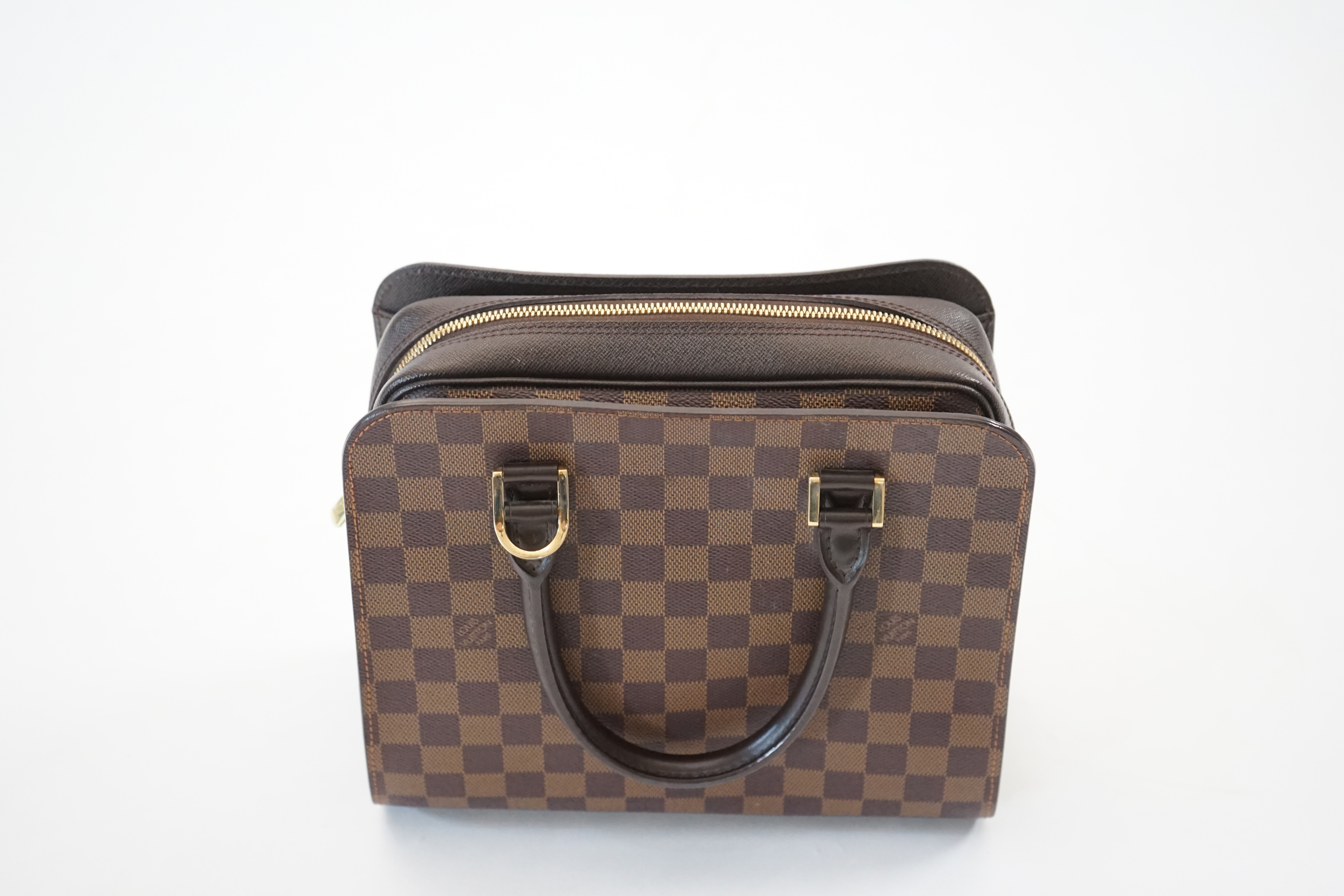A Louis Vuitton Triana handbag, styled in Damier canvas width 26cm, depth 12cm, height 22cm handle 11cm